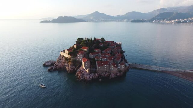 Aerial view of Sveti Stefan island and beach in Montenegro with stunning architecture and vibrant blue Adriatic Sea.