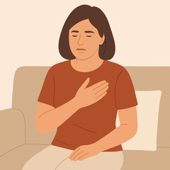 A woman with chest pain is sitting on the couch.