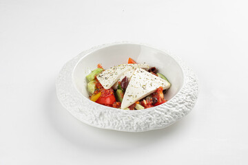 Portion of greek salad with fresh vegetables