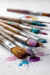 Fototapeta premium Paint Brushes Covered in Various Colors on White Canvas, Illustrating Artistic Expression and Creative Inspiration for Visual Arts Projects : Generative AI