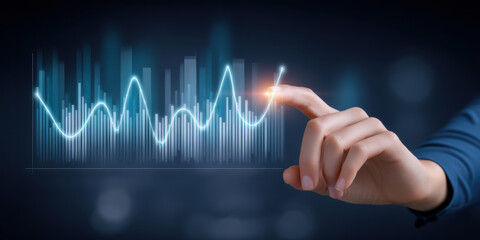 Digital e commerce concept with hand pointing at glowing graph line showing business growth and data analysis on dark background