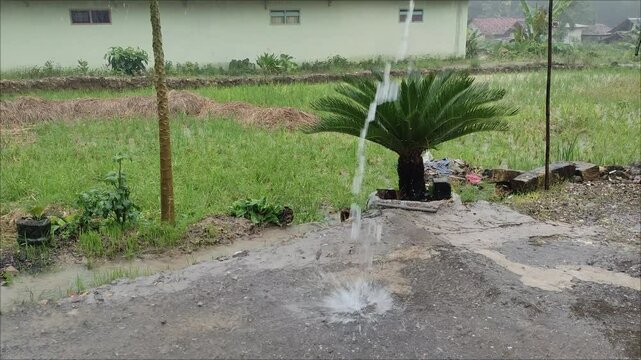 Heavy rain fell causing water to flow heavily from the rain gutter at home.