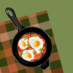 Fried egg with tomatoes and greens ia a fryer pan on the tablecloth. Shakshuka. Healthy breakfast concept