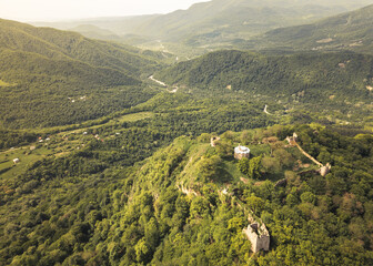 Aerial view ancient Bochorma fortress complex in Georgia surrounded by scenic Caucasus mountains....