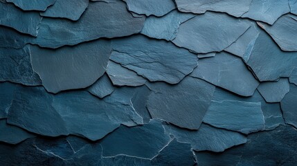 A detailed close-up of layered blue slate stones forms a visually captivating background that conveys a sense of earthiness and natural beauty, perfect for diverse design projects.