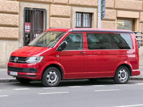 Red Volkswagen Transporter T6 van parked on street