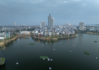 Beautiful view of West Lake in Hanoi city Vietnam during twilight with boats floating peacefully on the calm waters