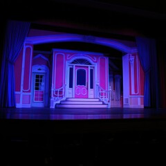 Vibrant Theatre Stage with Colorful Backdrop and Elegant Design