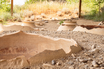 Clay wine vessels embedded in earth beneath wooden shelter at Armaziskhevi site, part of an ancient wine making cellar in Mtskheta region, Georgia