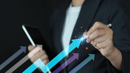 Close-up of hand holding pen over blue growth chart. Ideal for business growth, financial forecasting, investment performance