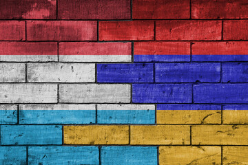 Fototapeta premium colourful painted big national flag of armenia and flag of luxembourg on a massive old brick wall background. concept
