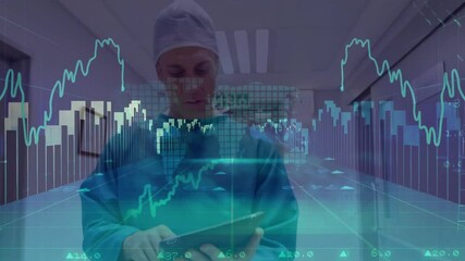 Healthcare worker raising tablet in hospital corridor and tapping while analyzing financial charts - Powered by Adobe
