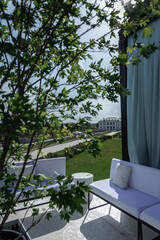  Inviting outdoor patio features comfortable seating surrounded by lush greenery. A serene setting with a spacious garden view, perfect for relaxation and contemplation.