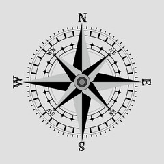 A stylized compass rose with eight sharp, silver-gray points radiating from a central gear-like hub, symbolizing direction, precision, and timeless exploration. Designed with a clean, modern aesthetic