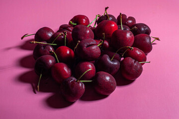 red cherries on a hot pink background