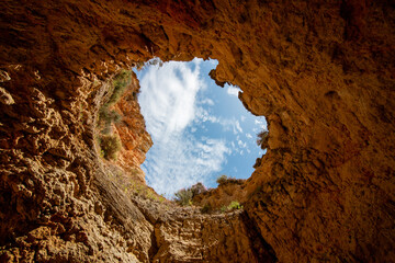 Looking Up at the Blue Sky Through the Famous Oculus of the Benagil Sea Cave (Algar de Benagil) in Algarve, Portugal