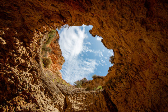 Looking Up at the Blue Sky Through the Famous Oculus of the Benagil Sea Cave (Algar de Benagil) in Algarve, Portugal