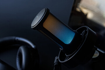 Close-up of a gaming microphone with colorful LED lighting, perfect for streaming, podcasting, and...
