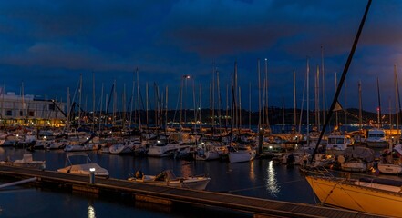 Panoramic photo of yachts in a marina on the banks of the Tagus in Lisbon at night