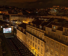 Viewers at a cinema on the roof of a tenement house in the Alfama district of Lisbon watch a film in the evening