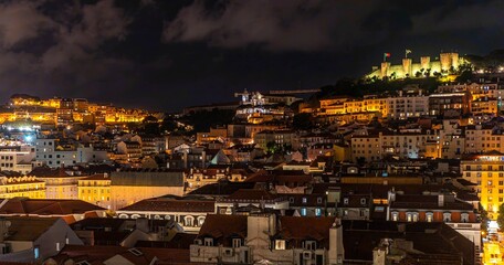Panoramic, night view of the Alfama district in Lisbon with the illuminated S. Jorge Castle on the hill