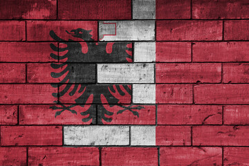 colourful painted big national flag of malta and flag of albania on a massive old brick wall background. concept