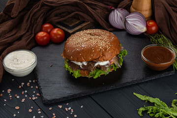 Burger on black background with sauce