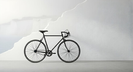 Obraz premium Sleek black bicycle against a textured white wall minimalist aesthetic