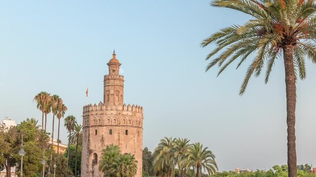 Torre del Oro timelapse hyperlapse, a dodecagonal military watchtower in Seville, Spain. Built by the Almohads to control Guadalquivir River access. Historic landmark at evening before sunset