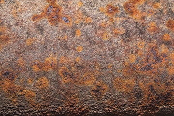 Rusty metal surface close-up macro texture, angled view highlighting weathered corrosion and rough detail