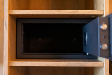 A lockable safe is positioned in an open wooden cabinet, showcasing its depth and design. Ideal for...