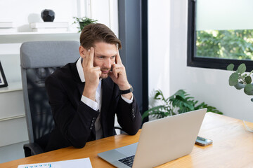 Caucasian businessman grab his head suffer from headache