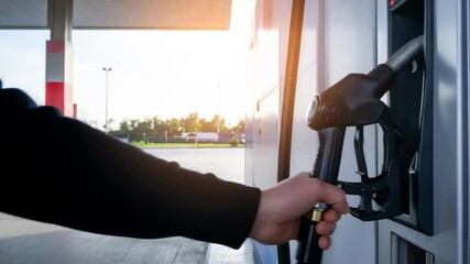 Camera operator filming scene using professional tripod at sunset, showing media production and behind-the-scenes work. - Powered by Adobe