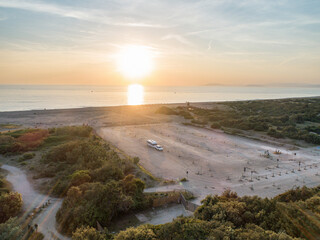 Camper rv caravan on mediterranean coast in Italy. Wild camping on sea shore. Holidays and travel in motor home