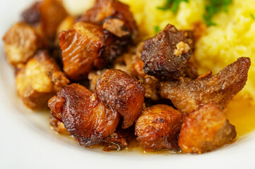 Pieces of juicy pork baked until brown with mashed potato.
