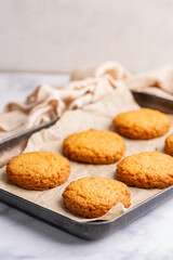 Homemade peanut or almond butter cookies or oatmeal cookies on white kitchen background. High quality photo