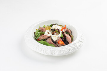 Portion of roast beef salad with stracciatella and tomatoes