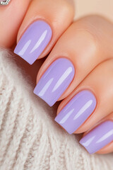 Soft elegance and serene tone: Hands with rectangular shaped nails, painted in a pastel lilac shade. Ideal for beauty, well-being and self-care themes.