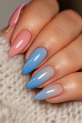 Delicate gradient: Hand with almond-shaped nails, featuring a soft gradient from pale pink to blue. Ideal for beauty themes, nail art trends, color transitions and an elegant look.