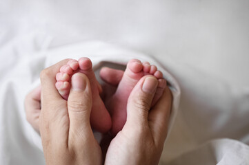 Parent Holding Newborn Baby Feet with Gentle Hands