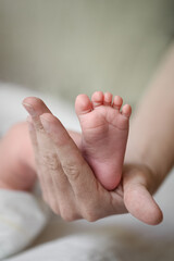 Parent Holding Newborn Baby Feet with Gentle Hands