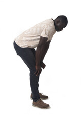 Naklejka premium side view of a man standing leaning forward look down on white background