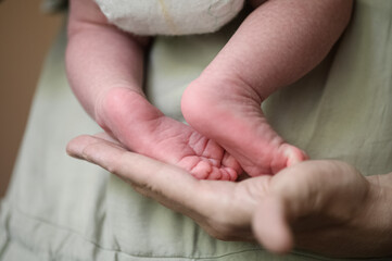Parent Holding Newborn Baby Feet with Gentle Hands