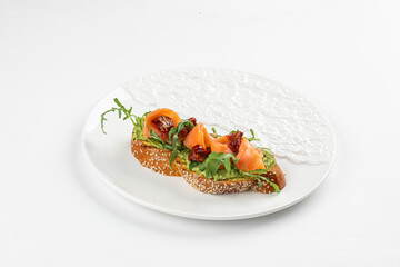 Plate of gourmet bruschetta with salmon and dried tomatoes