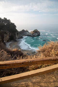 Iconic McWay Falls Cascading onto a Secluded Beach in a Turquoise Cove at Sunset in Big Sur, California