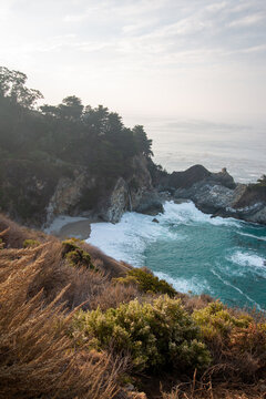 Atmospheric View of McWay Falls on a Moody, Foggy Day Along the Rugged Big Sur Coast in California