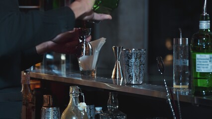 Closeup mixing hand bartender holding jigger to measure lemon juice into shaker design preparation for mixed cocktail bar. Special refresh drink showcasing nightlife mixology inviting club. Vinosity.