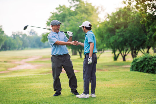 Senior Golfer and Young Golfer enjoying golf together at golf course, playing with fun in summer vacation, outdoor activity with happy family bonding.