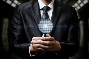 Pro in suit examines AI symbol with magnifier.