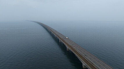 infinite bridge running into the water, highway mobility infrastructure. Aerial photo